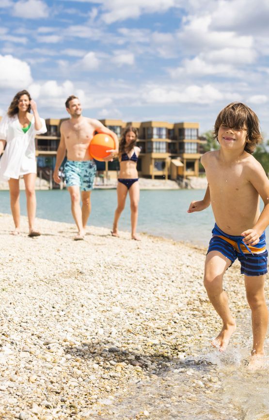 Family playing with a ball on Summer Island at St. Martins thermal baths  and Lodge